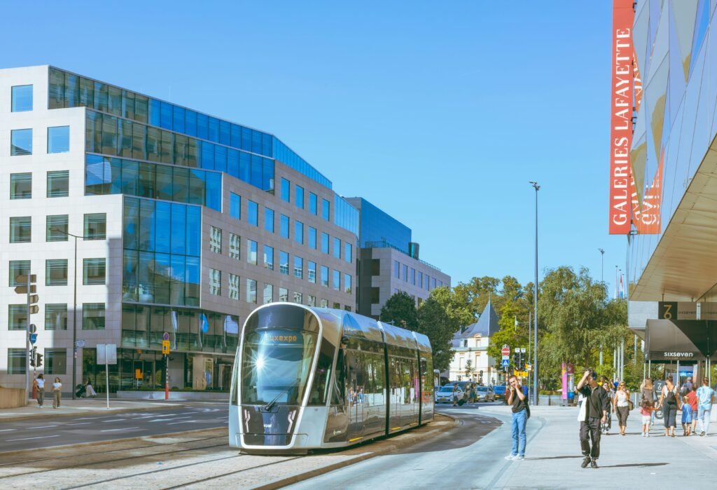A scenic view of modern tram and urban architecture in Luxembourg city streets.