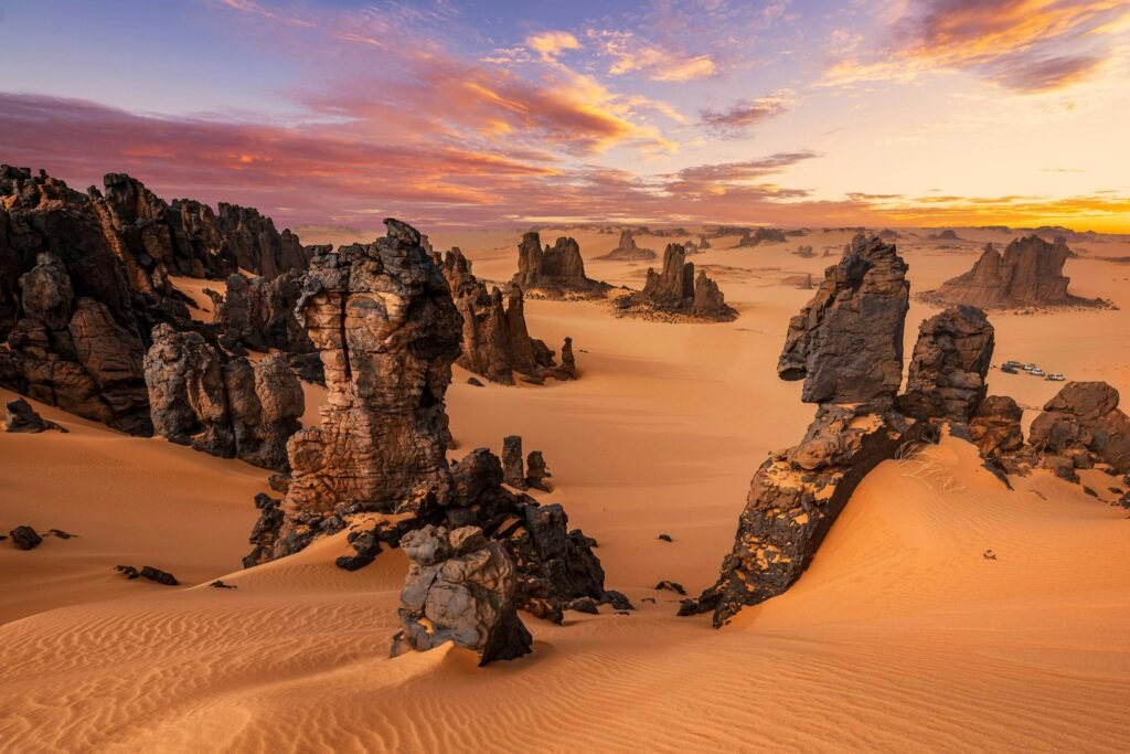 Explore the breathtaking rock formations and dunes of Tamanrasset, Algeria at sunset.